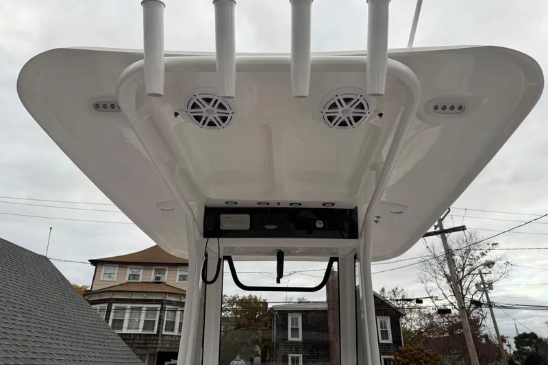 Slide: The Image of 2026 Sea Hunt Ultra 245 SE boat T-top with speakers and rod holders. - 16