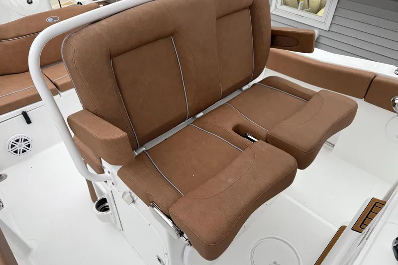 Slide: The Image of Brown seating on 2026 Sea Hunt Ultra 245 SE boat, featuring white frame and cup holders. - 19