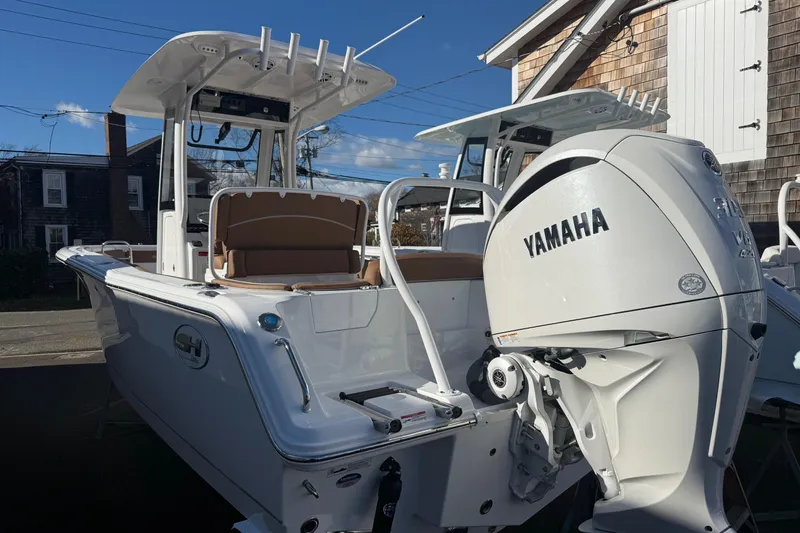 Slide: The Image of 2026 Sea Hunt Ultra 245 SE boat with Yamaha engine, docked outdoors. - 20