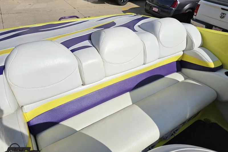 Slide: The Image of 2005 Baja 25 Outlaw boat interior with white, yellow, and purple seating. - 101