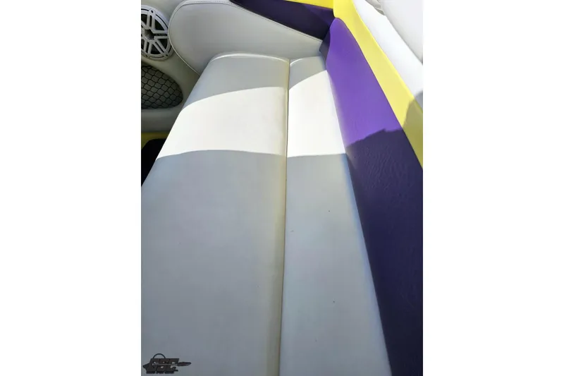 Slide: The Image of 2005 Baja 25 Outlaw boat interior with white, purple, and yellow seating. - 102