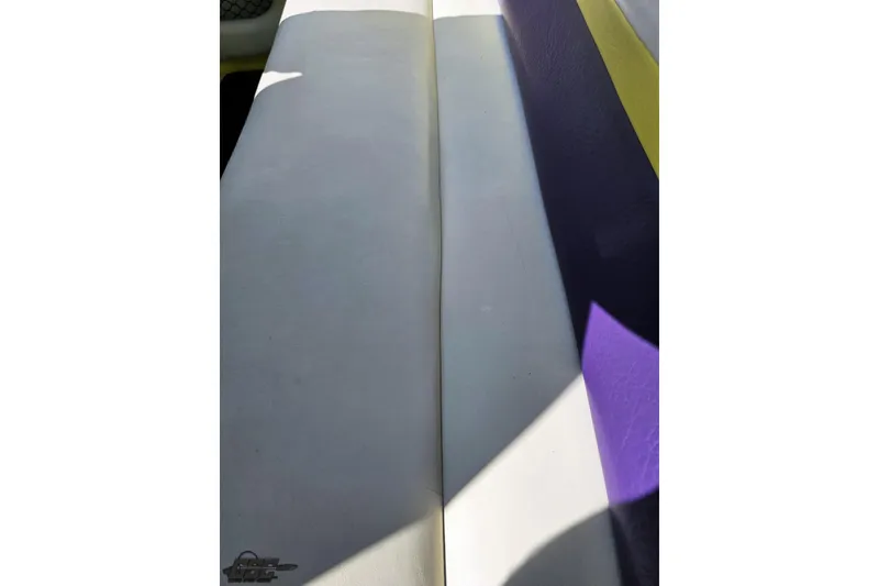 Slide: The Image of 2005 Baja 25 Outlaw boat interior with white and purple seating. - 103
