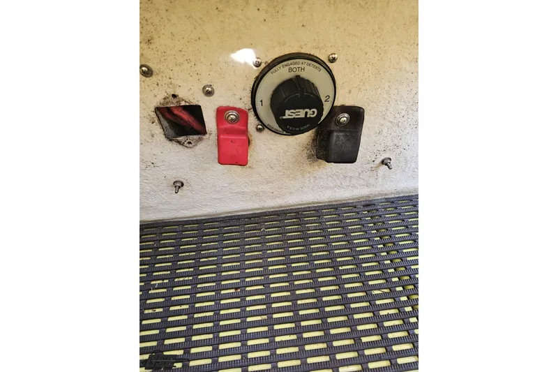 Slide: The Image of 2005 Baja 25 Outlaw boat battery switch panel with red and black covers. - 106