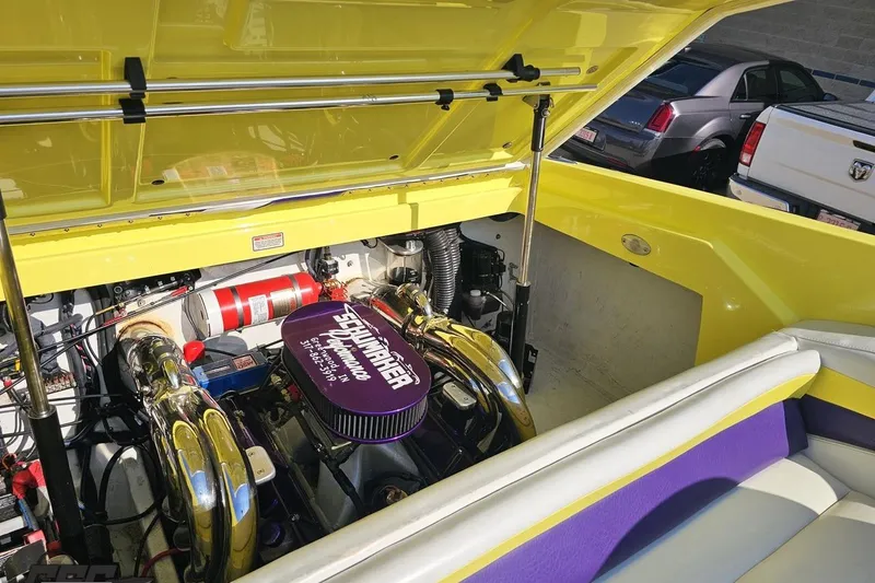 Slide: The Image of 2005 Baja 25 Outlaw boat engine compartment with vibrant yellow and purple accents. - 109