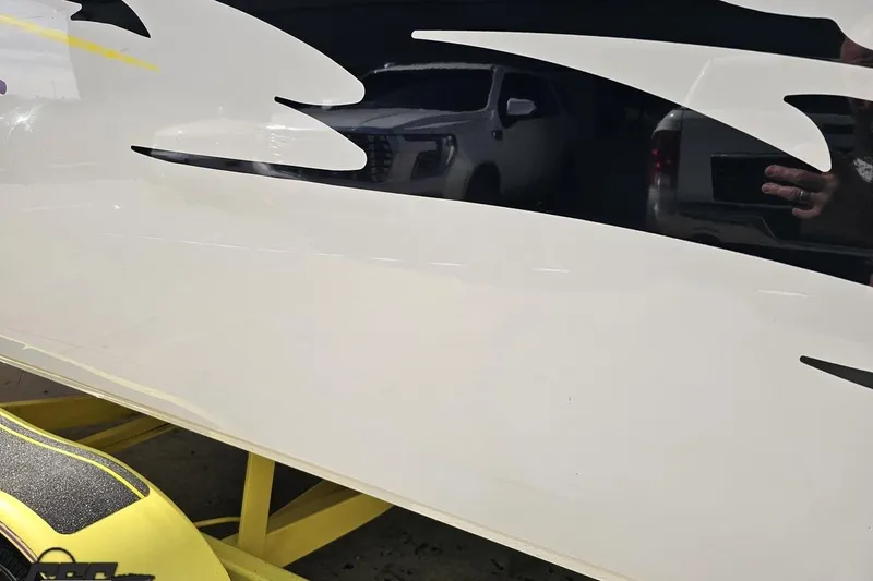 Slide: The Image of 2005 Baja 25 Outlaw boat with sleek design and vibrant graphics. - 38