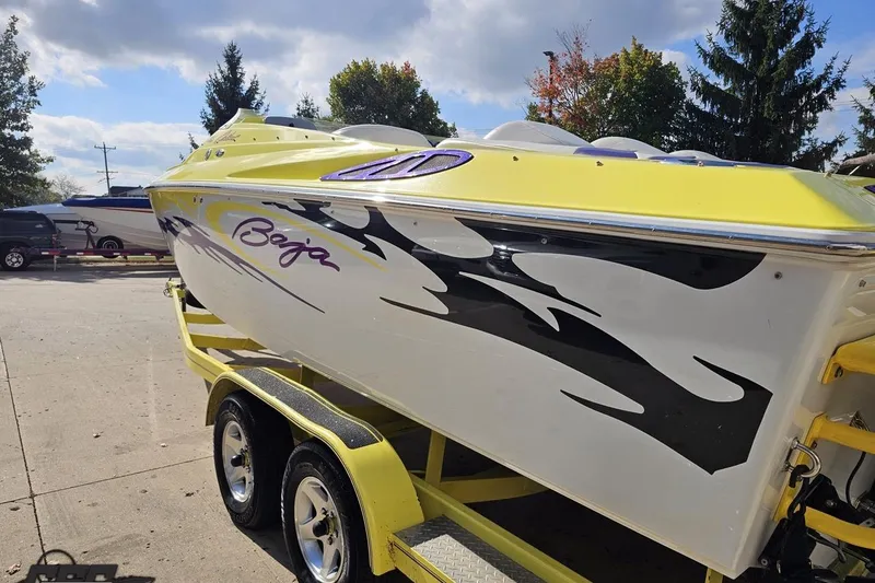 Slide: The Image of 2005 Baja 25 Outlaw speedboat with vibrant yellow and black design on trailer. - 39
