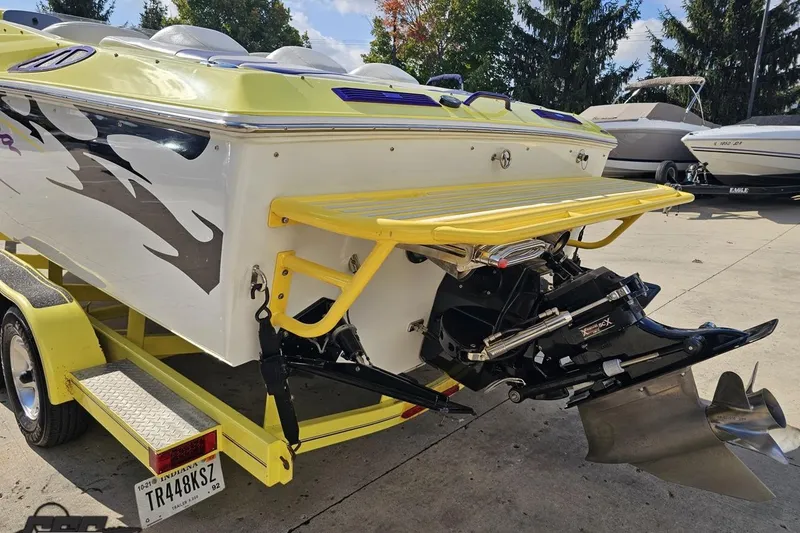 Slide: The Image of 2005 Baja 25 Outlaw boat on trailer, featuring vibrant yellow accents and sleek design. - 40