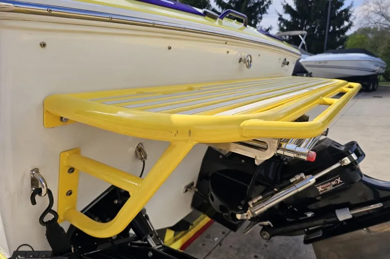 Slide: The Image of 2005 Baja 25 Outlaw boat with yellow swim platform and outboard motor. - 41