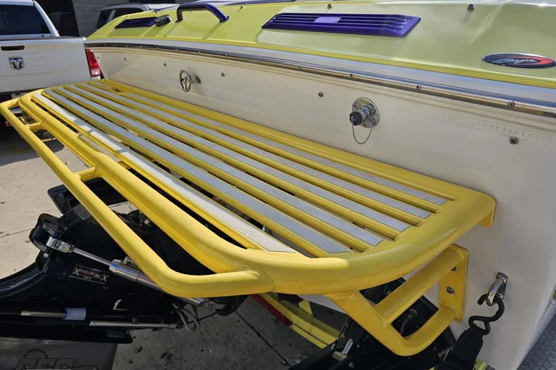 Slide: The Image of 2005 Baja 25 Outlaw boat with yellow swim platform and purple accents. - 50