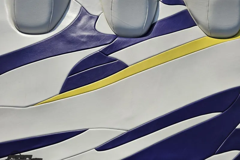 Slide: The Image of Colorful upholstery design on 2005 Baja 25 Outlaw boat seat, featuring blue, yellow, and white patterns. - 57