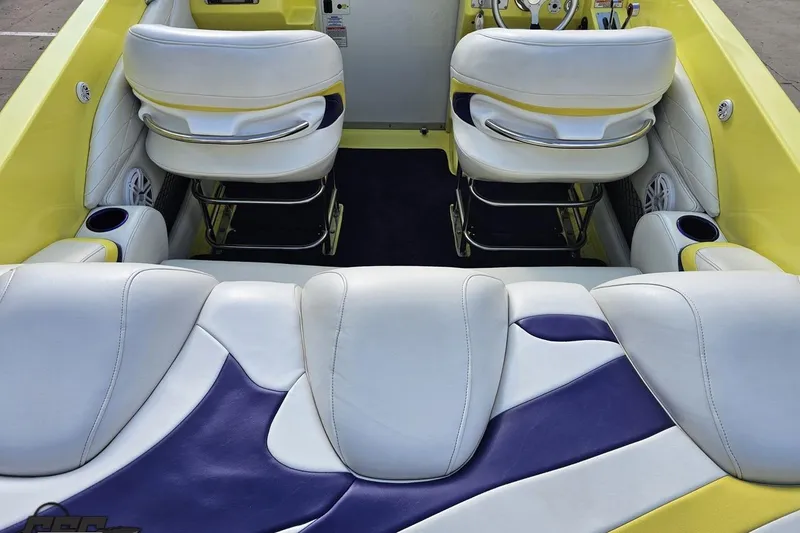 Slide: The Image of 2005 Baja 25 Outlaw boat interior with white and yellow seating, purple accents. - 59