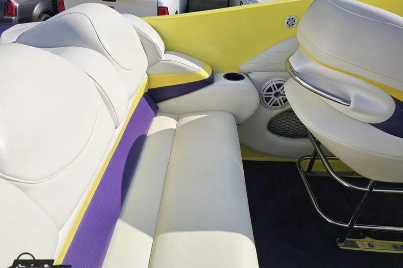 Slide: The Image of 2005 Baja 25 Outlaw boat interior with white, yellow, and purple seating. - 68