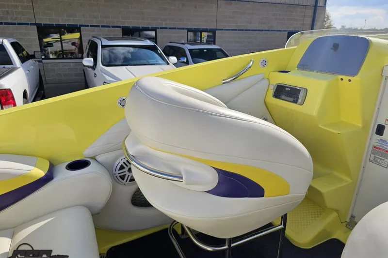 Slide: The Image of 2005 Baja 25 Outlaw boat interior with yellow and white seating, dashboard view. - 71