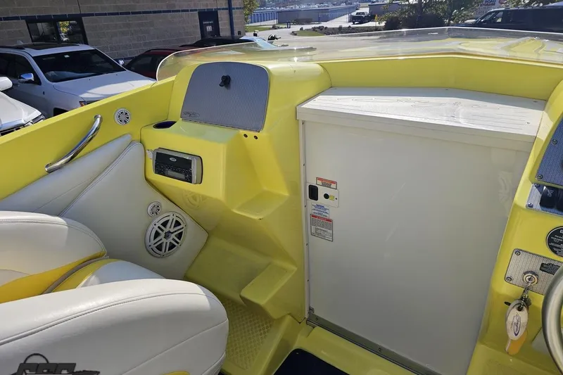 Slide: The Image of 2005 Baja 25 Outlaw boat interior with yellow accents and white seating. - 74