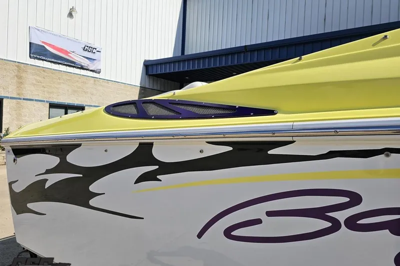 Slide: The Image of 2005 Baja 25 Outlaw boat with vibrant yellow and black flame design. - 8