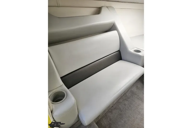 Slide: The Image of 2005 Baja 25 Outlaw interior seating with cup holders, featuring sleek gray upholstery. - 88