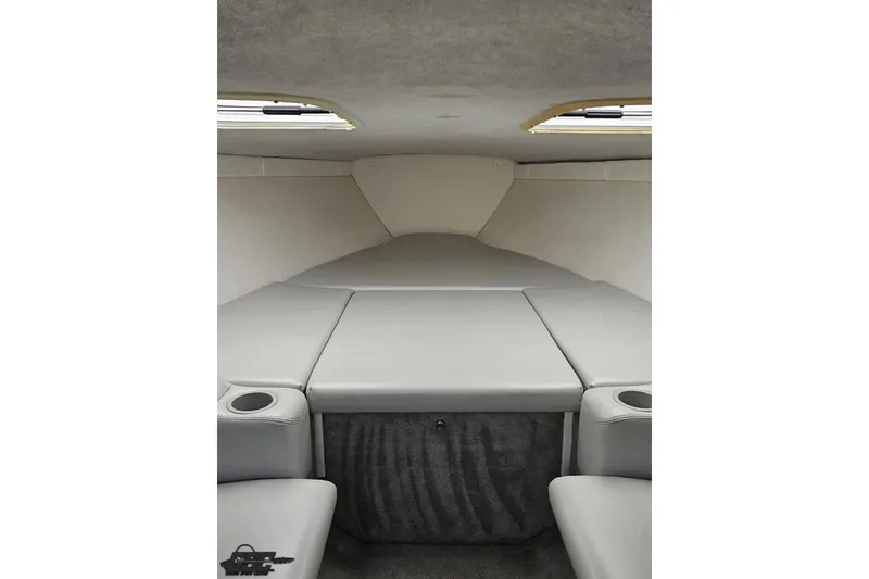 Slide: The Image of 2005 Baja 25 Outlaw boat interior cabin with gray upholstery and cup holders. - 89