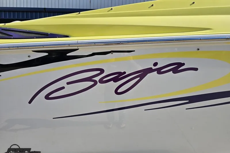 Slide: The Image of 2005 Baja 25 Outlaw boat with yellow and purple graphics. - 9