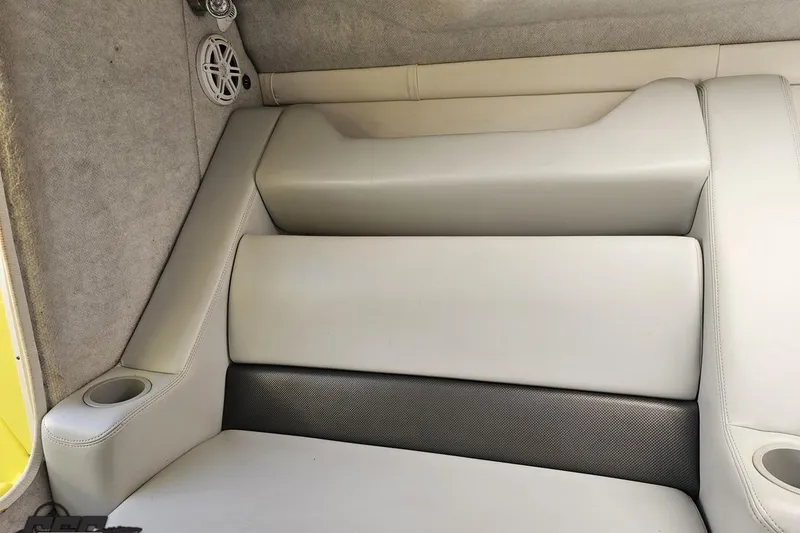 Slide: The Image of 2005 Baja 25 Outlaw boat interior with cushioned seating and speaker. - 91