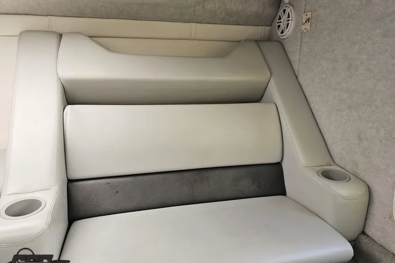 Slide: The Image of 2005 Baja 25 Outlaw boat interior with cushioned seating and cup holders. - 92