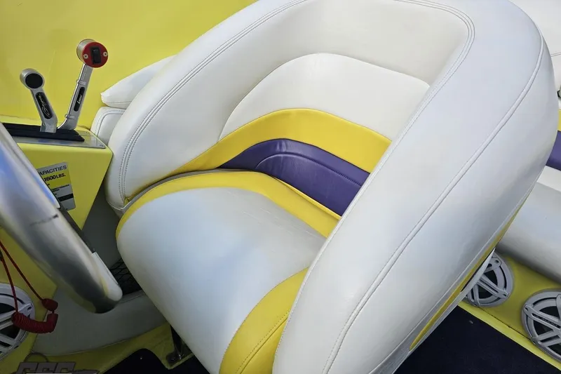 Slide: The Image of 2005 Baja 25 Outlaw boat interior with white, yellow, and purple seating. - 98