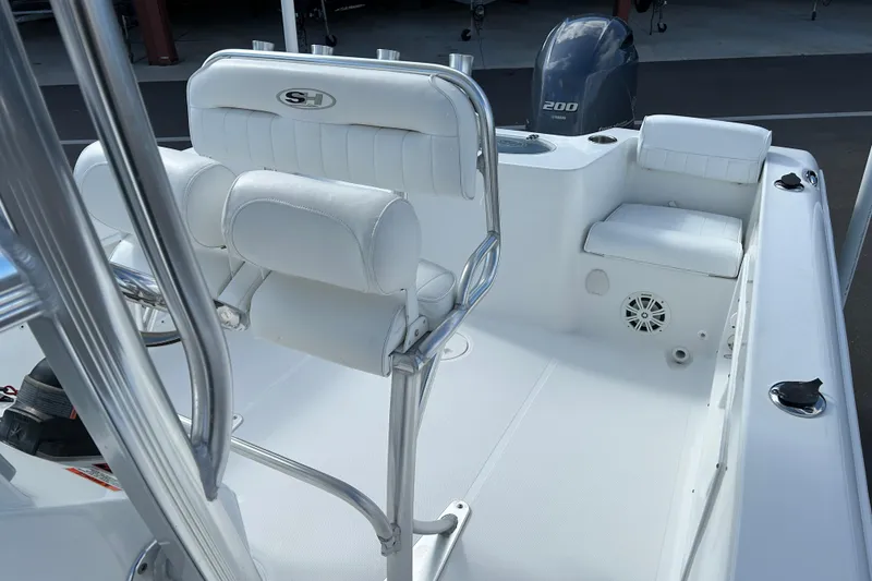 Slide: The Image of 2016 Sea Hunt Triton 225 boat interior with white seating and Yamaha 200 engine. - 11