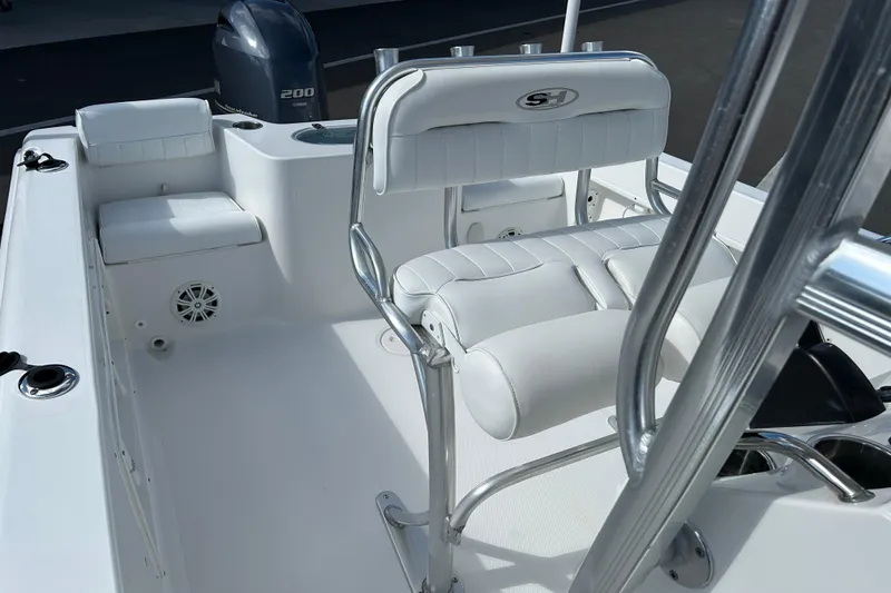 Slide: The Image of 2016 Sea Hunt Triton 225 boat interior with white seating and Yamaha 200 engine. - 12