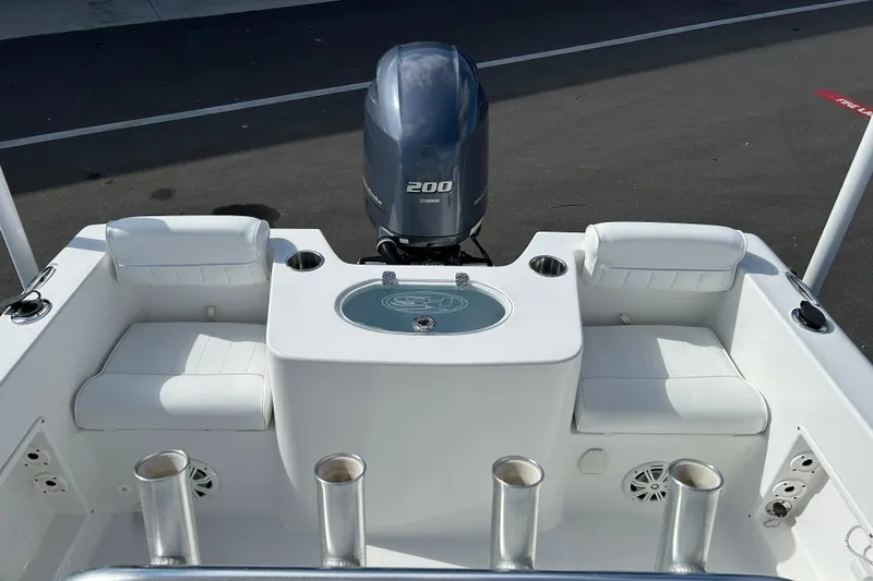 Slide: The Image of 2016 Sea Hunt Triton 225 boat interior with seating and Yamaha 200 outboard motor. - 13