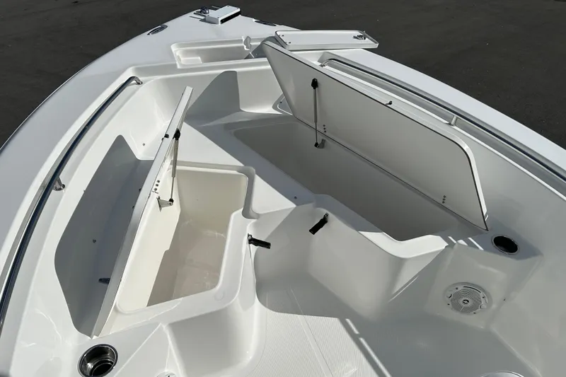 Slide: The Image of 2016 Sea Hunt Triton 225 boat interior with open storage compartments. - 16