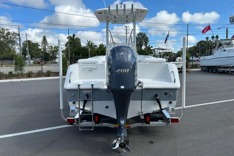 Slide: The Image of 2016 Sea Hunt Triton 225 boat with Yamaha 200 outboard motor, parked outdoors. - 3