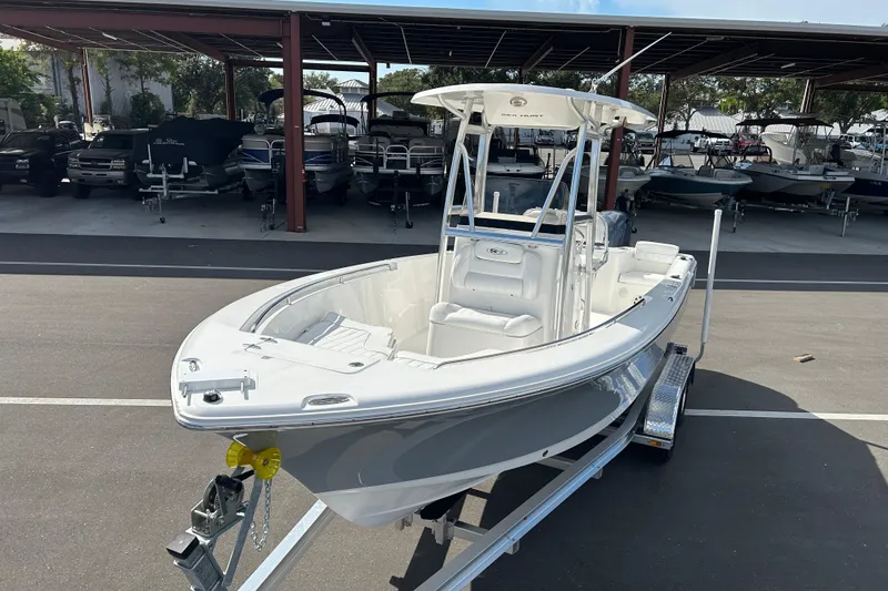Slide: The Image of 2016 Sea Hunt Triton 225 boat on trailer in marina parking area. - 6