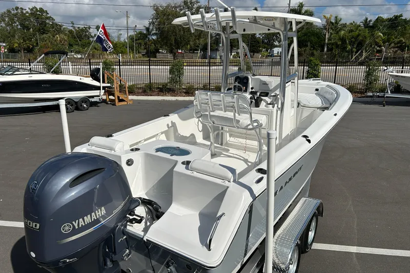 Slide: The Image of 2016 Sea Hunt Triton 225 boat with Yamaha engine, parked on a trailer. - 7