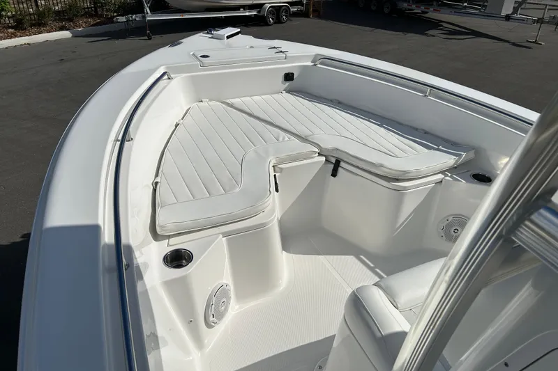 Slide: The Image of 2016 Sea Hunt Triton 225 boat interior with white cushioned seating and cup holders. - 8