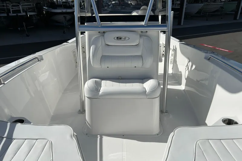 Slide: The Image of 2016 Sea Hunt Triton 225 boat interior with white seating and stainless steel railings. - 9
