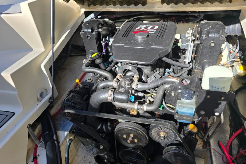 Slide: The Image of Engine compartment of a 2006 Azure AZ 220 boat, featuring a 5.0L engine. - 12