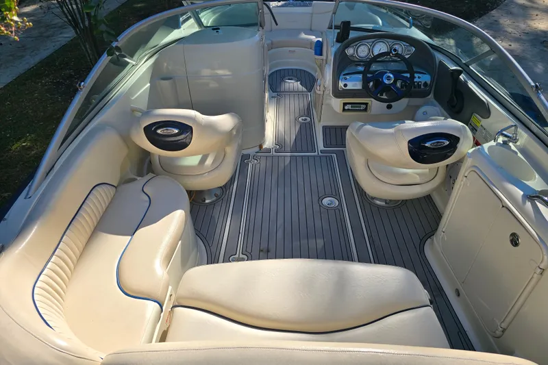 Slide: The Image of Interior of a 2006 Azure AZ 220 boat with beige seating and modern dashboard. - 14