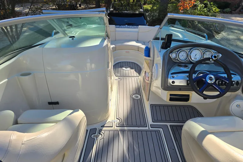 Slide: The Image of Interior of a 2006 Azure AZ 220 boat with steering wheel and seating. - 15