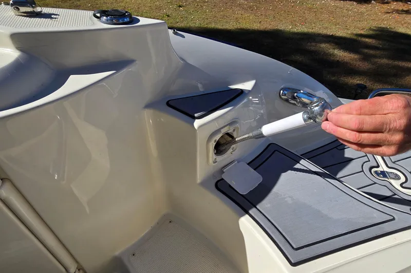 Slide: The Image of Hand cleaning boat drain on 2006 Azure AZ 220 deck. - 22