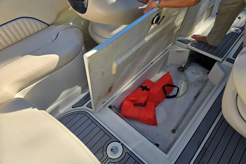 Slide: The Image of Open storage compartment on 2006 Azure AZ 220 boat with life jackets inside. - 25