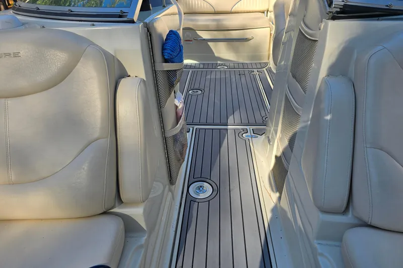 Slide: The Image of Interior of a 2006 Azure AZ 220 boat with beige seating and wooden flooring. - 26