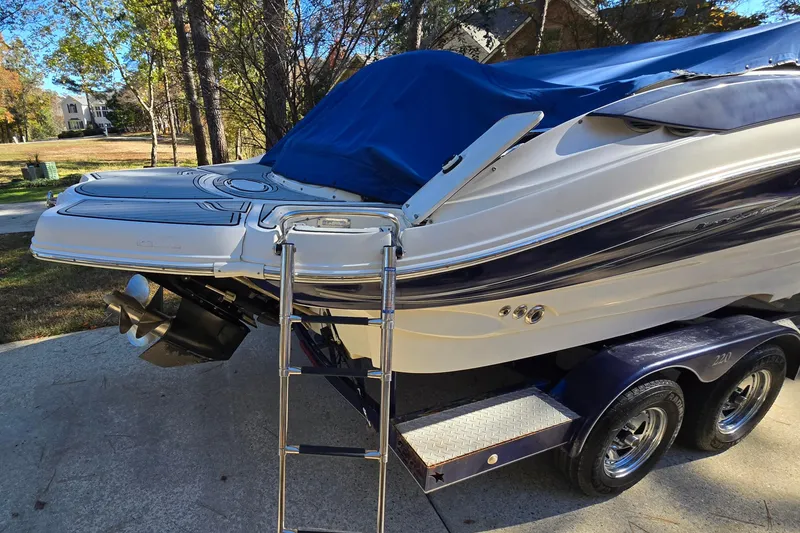 Slide: The Image of Azure AZ 220 boat, 2006 model, on trailer with cover and ladder, parked outdoors. - 7