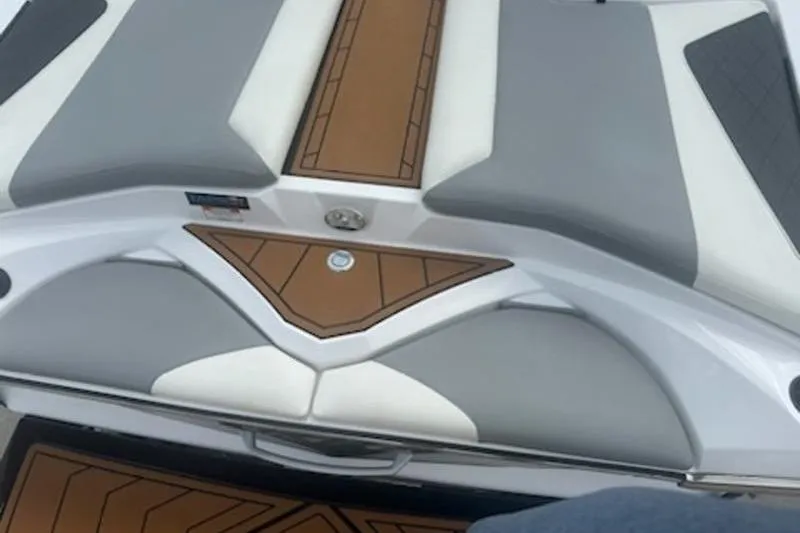 Slide: The Image of 2020 Tigé R23 boat interior with gray and brown cushioned seating. - 2