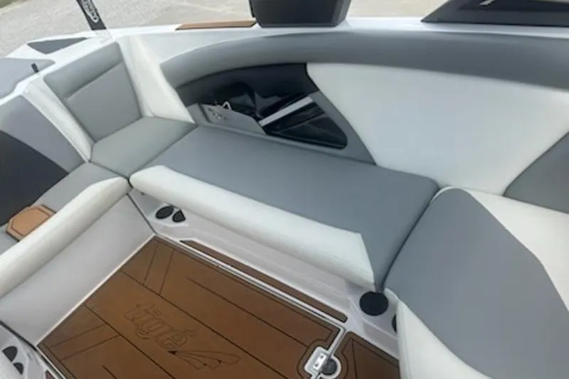 Slide: The Image of 2020 Tigé R23 boat interior with gray and white seating and brown flooring. - 5
