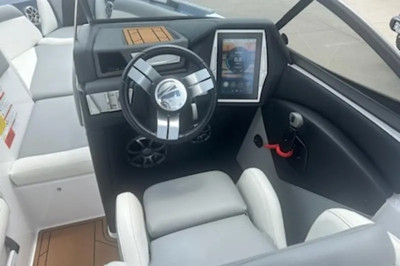 Slide: The Image of 2020 Tigé R23 boat interior with modern steering and touchscreen display. - 6