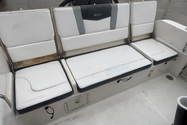 Slide: The Image of 2021 Robalo R230 Center Console boat interior with steering wheel and Garmin display. - 11