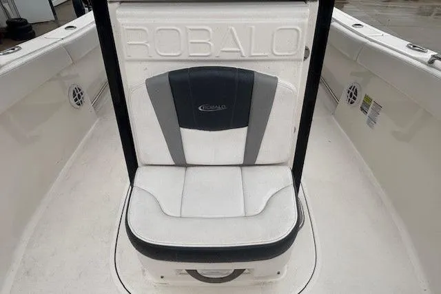 Slide: The Image of 2021 Robalo R230 Center Console boat interior with seating and storage compartments. - 19