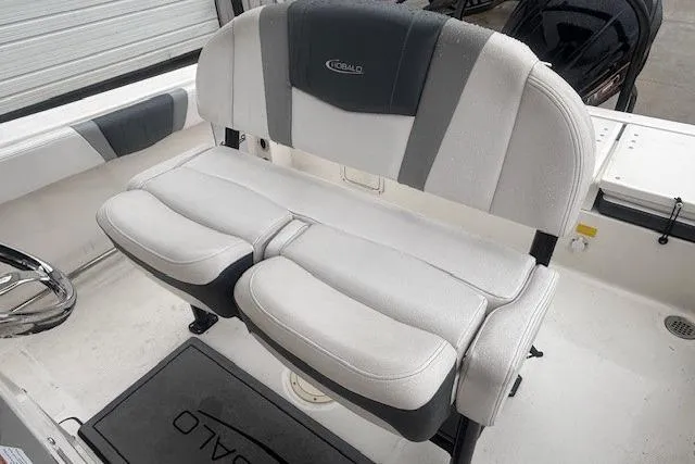 Slide: The Image of 2021 Robalo R230 Center Console interior with radio equipment and storage shelf. - 26