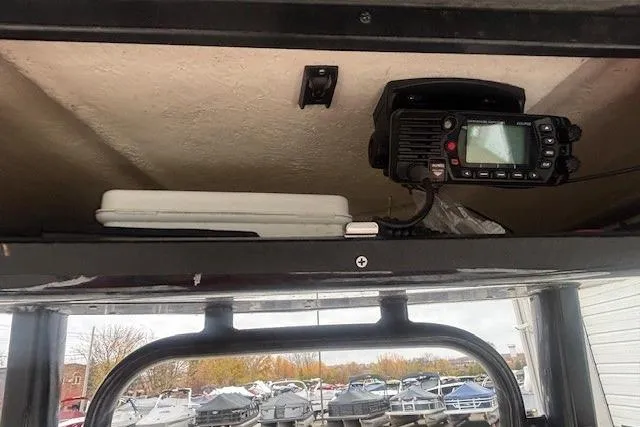 Slide: The Image of 2021 Robalo R230 Center Console boat on trailer, parked outside a warehouse. - 27