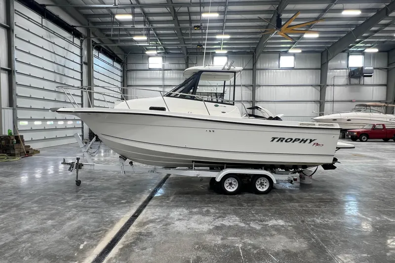 Slide: The Image of 2006 Trophy 2352 WA boat on trailer in spacious indoor storage facility. - 0