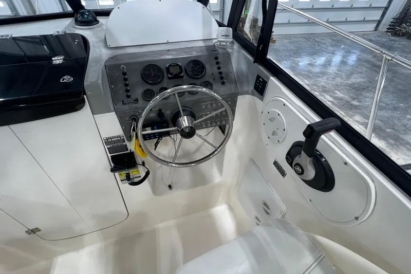 Slide: The Image of 2006 Trophy 2352 WA boat cockpit with steering wheel and control panel. - 10